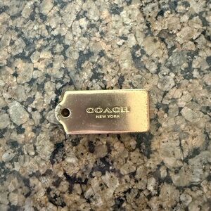 Coach Gold Tone Rectangular Logo Tag Charm